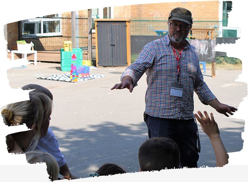 Volunteer talking to children in a playground